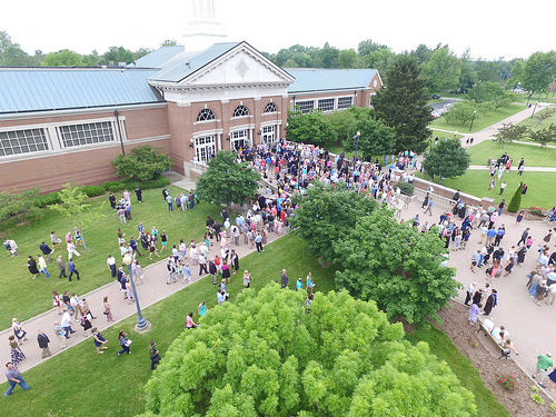 aerial view of campus building with crowd